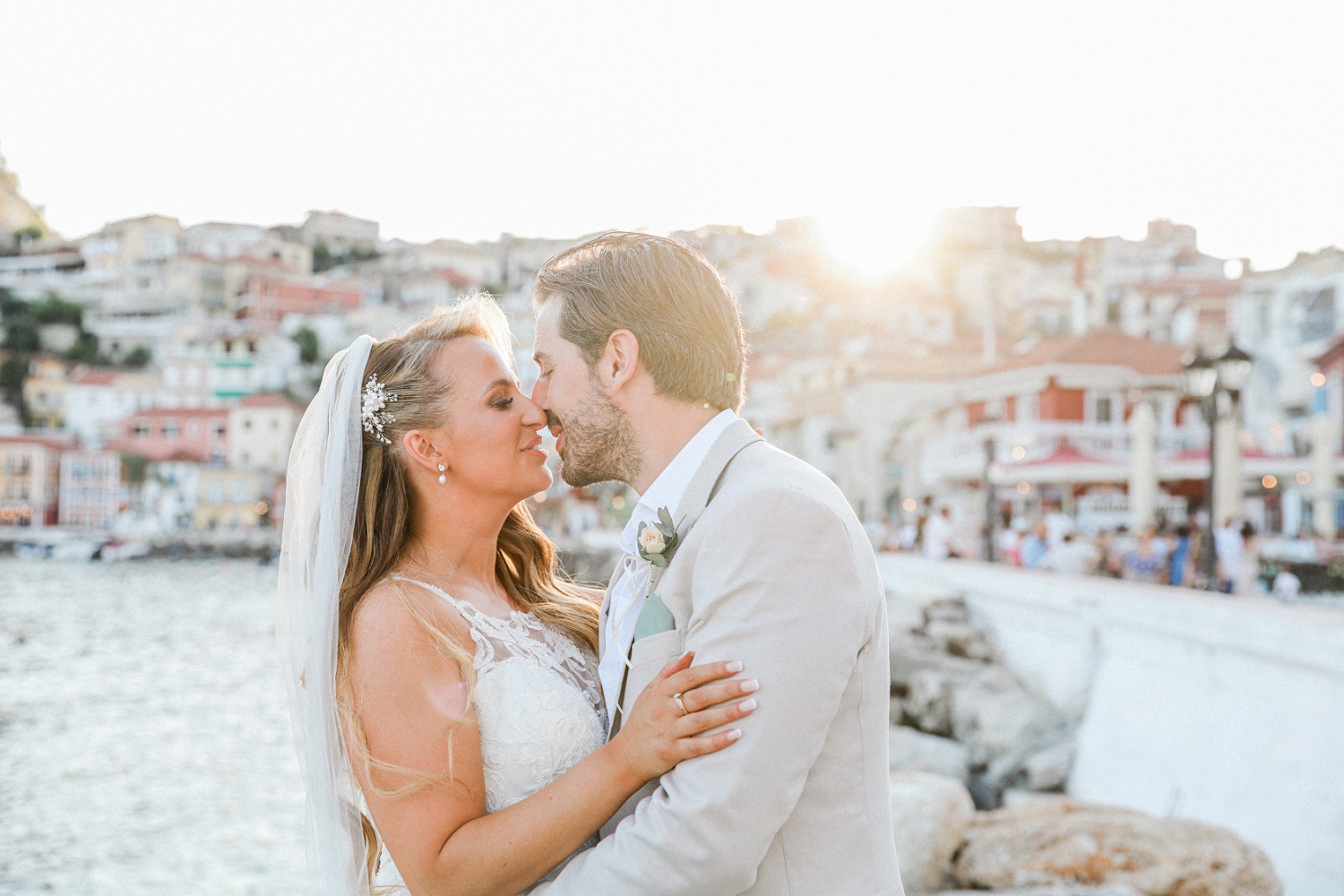 Bride in a Stella York dress and groom at sunset in Parga harbour