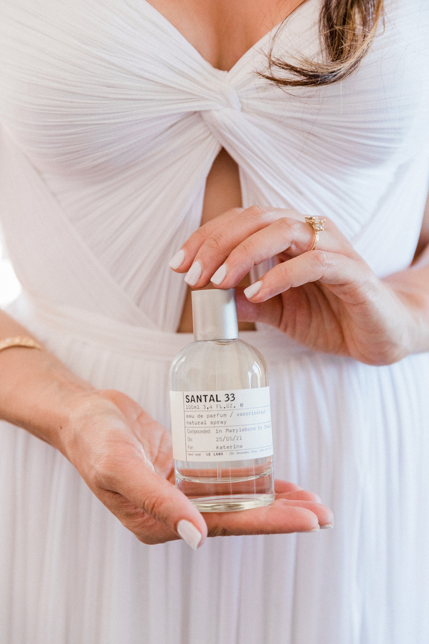 Bride holds her Le Labo fragrance on the morning of her wedding