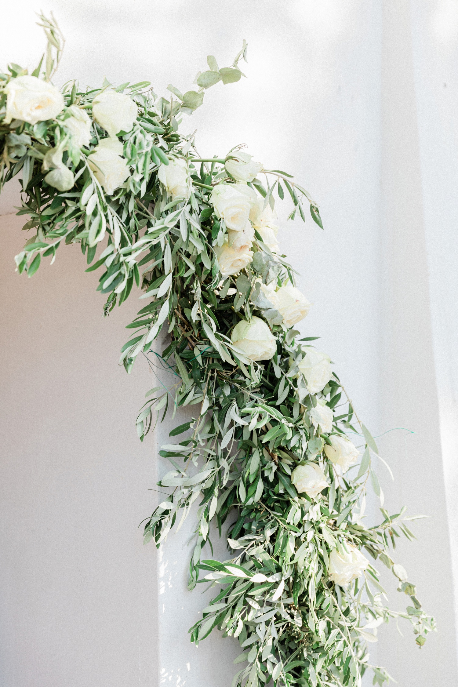 Olive and white rose garland decorating the door of the church on Lazaretto Islet in Ithaca