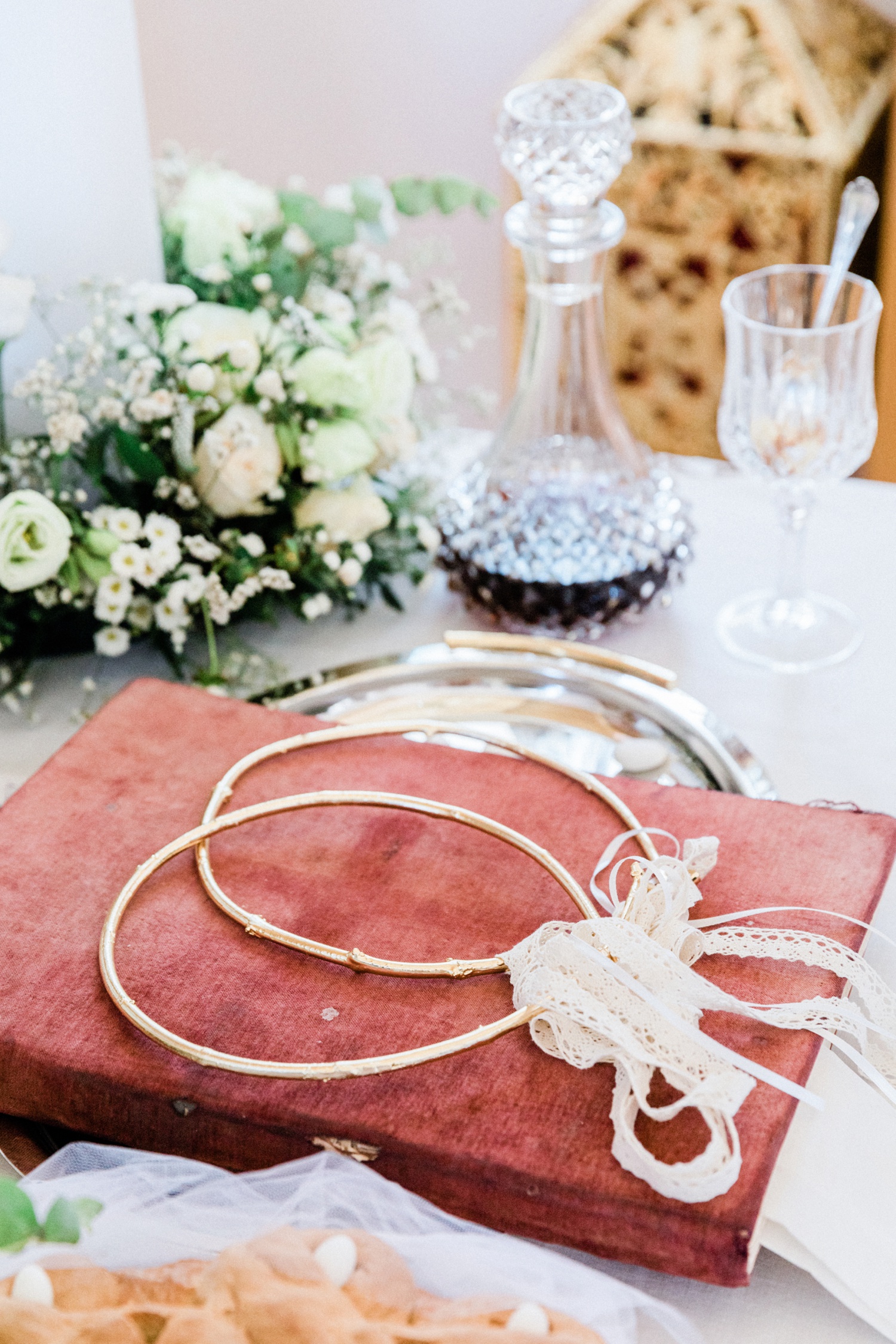 Greek church wedding table with decorated candles, a bible and Greek wedding crowns