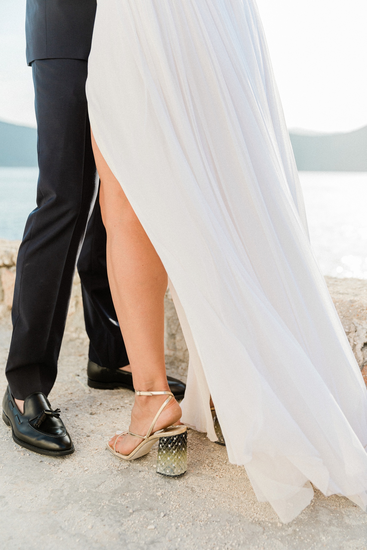 Detail image of a bride wearing statement gold and green Jimmy Choo heels with a Dana Harel gown