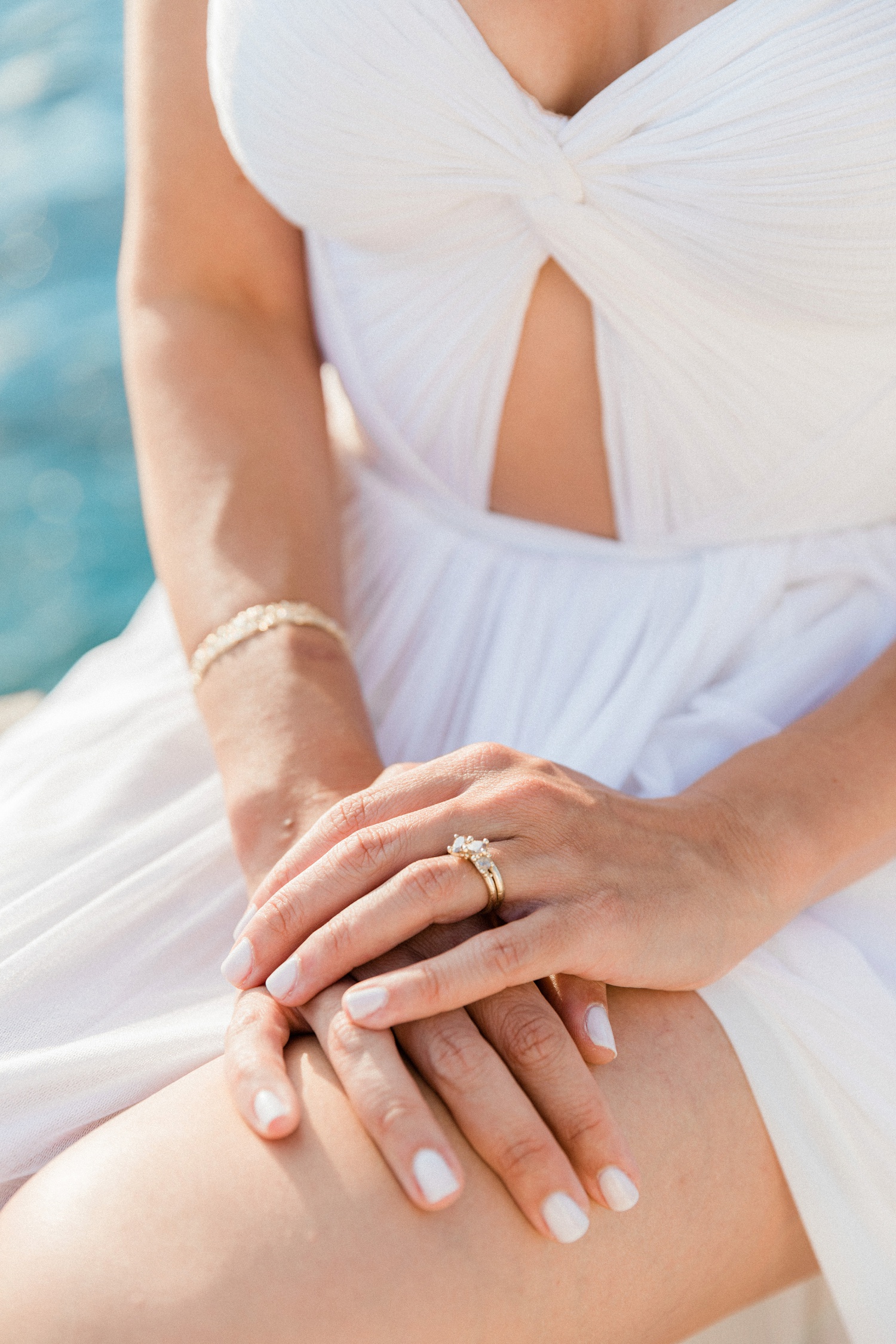 Bride wears her Ruth Tomlinson diamond cluster engagement ring on Ithaca in Greece