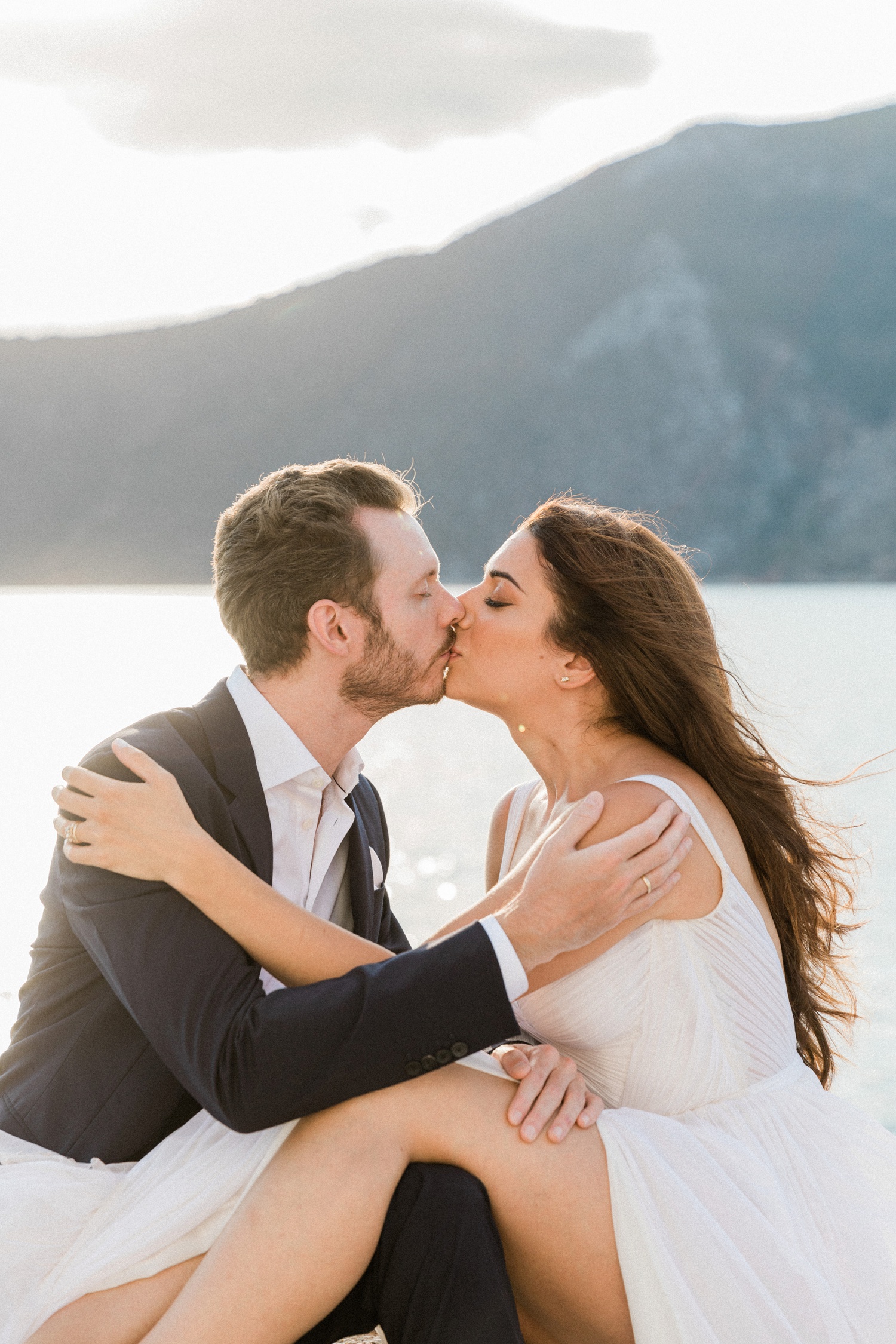 Couple kiss at sunset at their Ithaca island wedding 