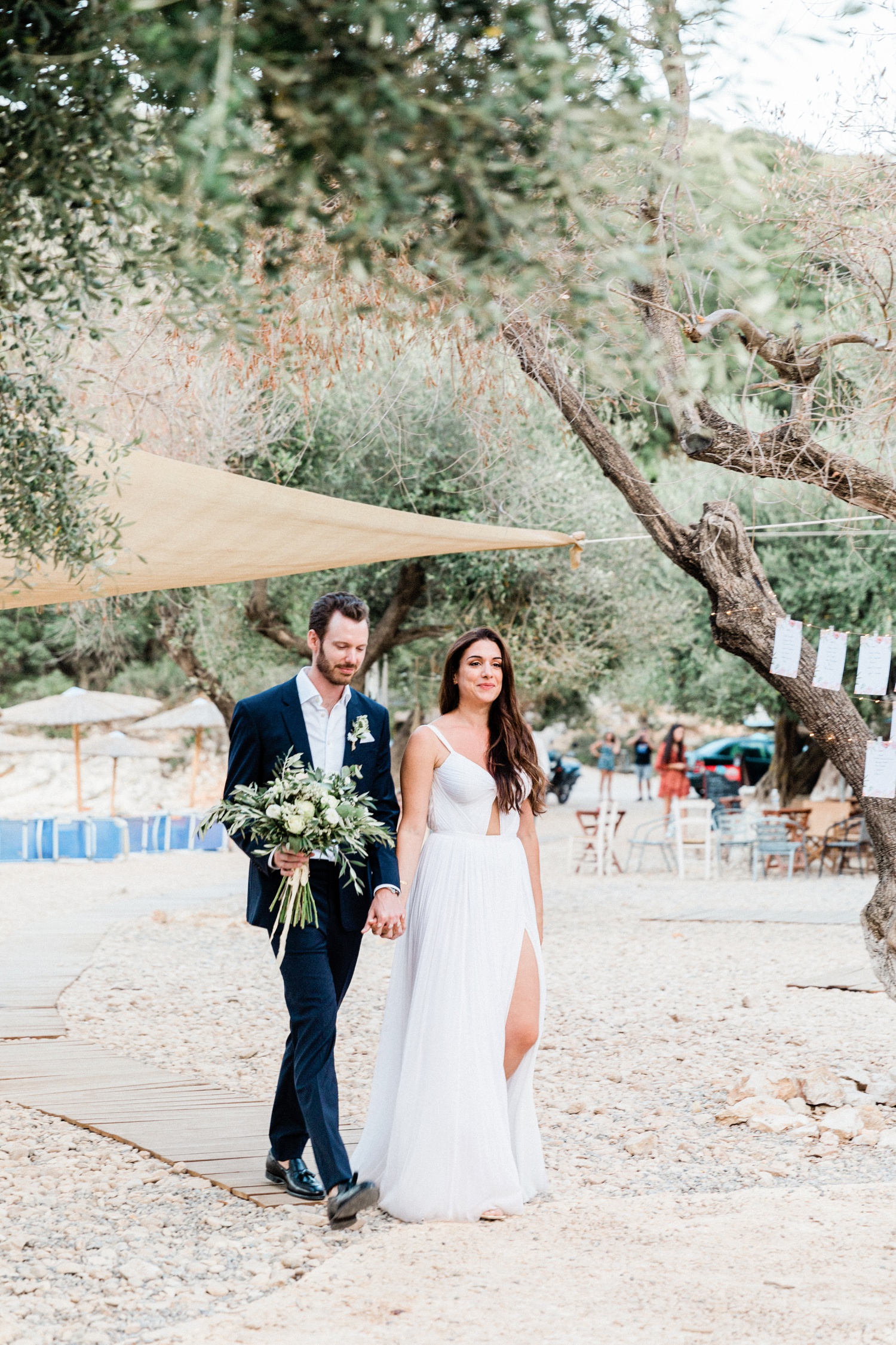 Bride and groom arrive at their olive grove wedding at Kirki on Filiatro beach on Ithaca