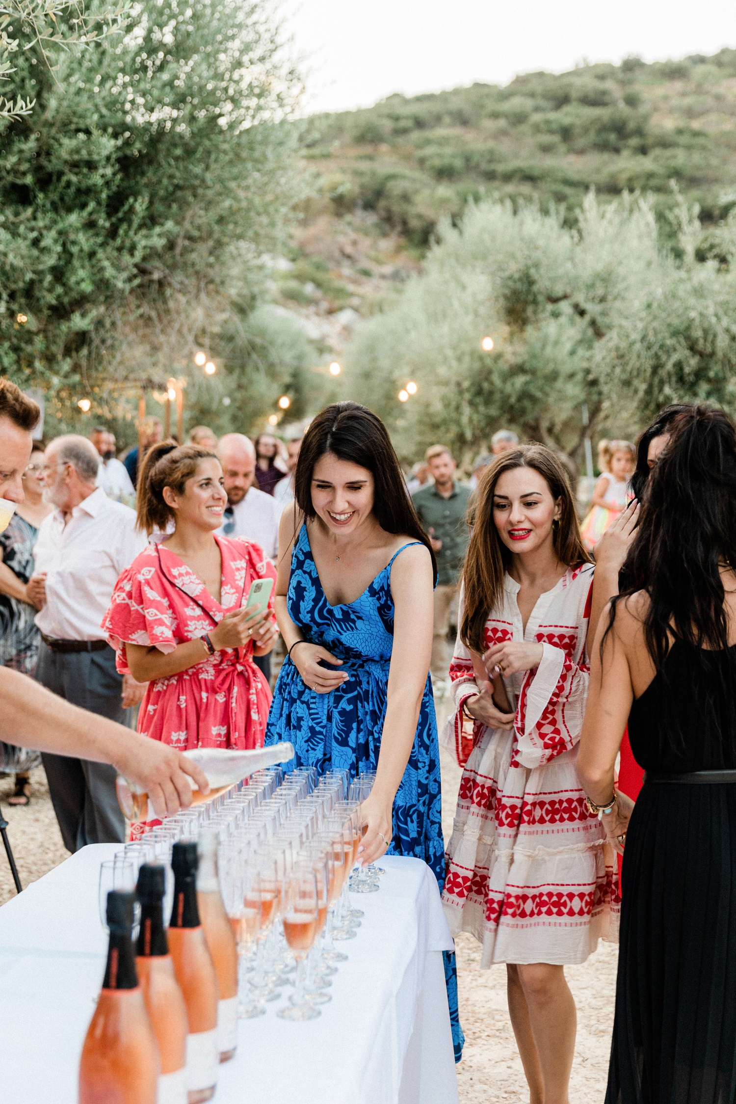 Guests enjoy champagne during cocktail hour at a wedding at Kirki on Ithaca