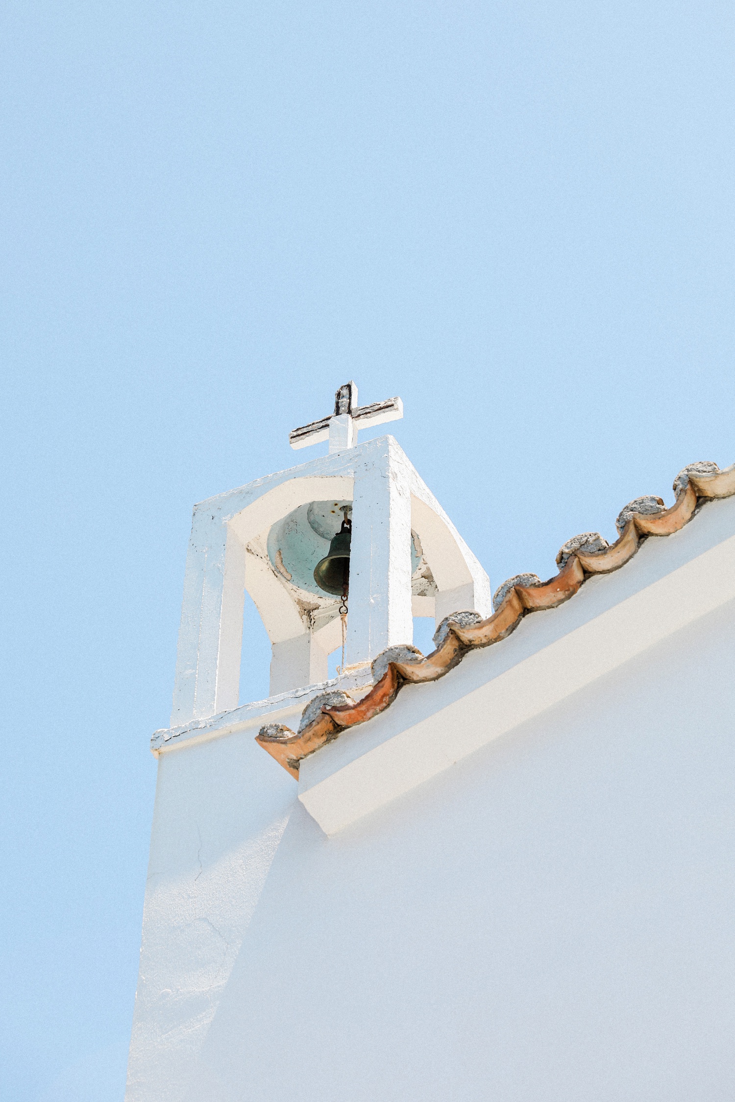 Blue skides behing the white Agios Andreas church steeple on Ithaca island