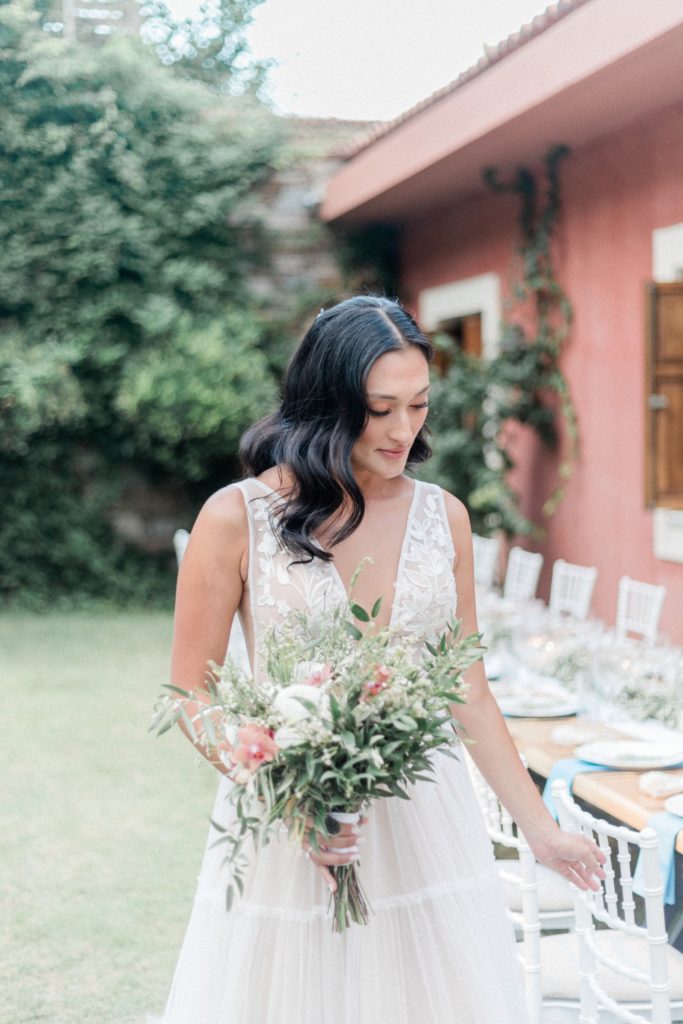 Bride admires her receptions tables and decor on her wedding day at Villa Veneziano